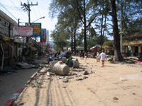 Patong's beach road is covered in sand and debris