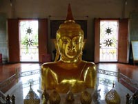 The golden Buddha image emrging from the ground at Wat Phra Thong