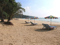 A few sun loungers are spread along Nai Thon Beach during the high season